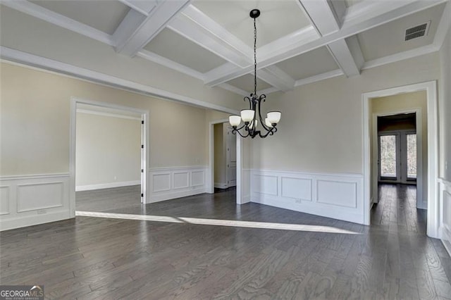 unfurnished dining area with coffered ceiling, dark wood-type flooring, an inviting chandelier, and beam ceiling