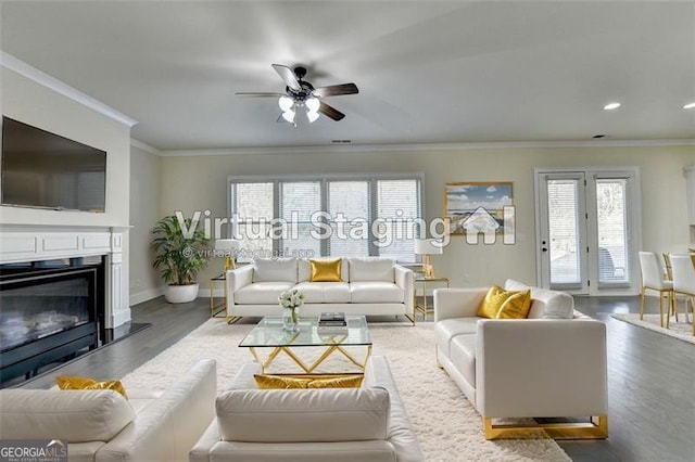 living room featuring hardwood / wood-style flooring, ornamental molding, and ceiling fan