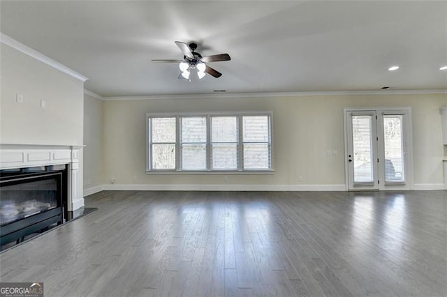 unfurnished living room with hardwood / wood-style flooring, ceiling fan, and ornamental molding