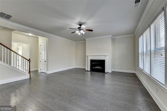 unfurnished living room featuring dark wood-type flooring, ceiling fan, and ornamental molding