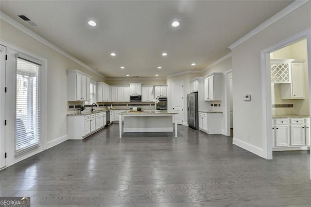 kitchen featuring white cabinetry, sink, dark hardwood / wood-style floors, and appliances with stainless steel finishes