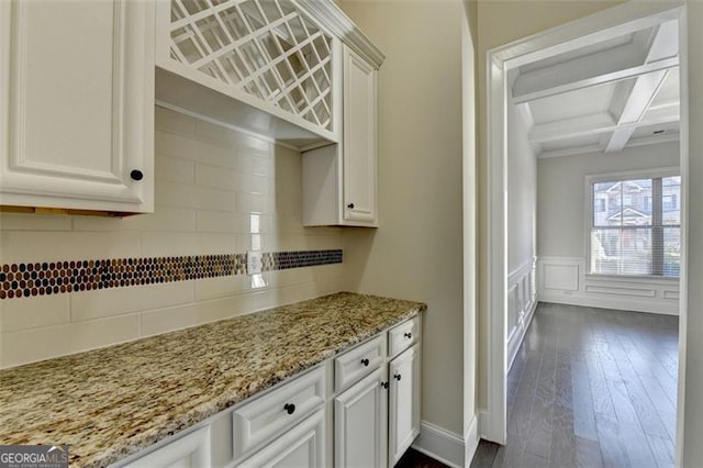 kitchen featuring white cabinets, decorative backsplash, coffered ceiling, dark wood-type flooring, and beam ceiling