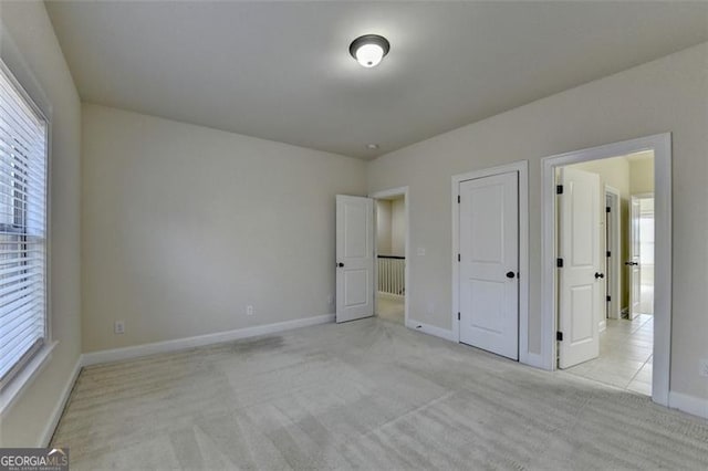 unfurnished bedroom with light colored carpet