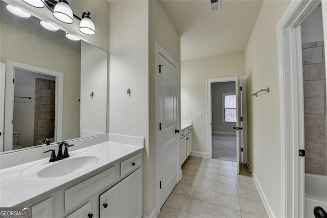 bathroom with tile patterned floors, vanity, and toilet