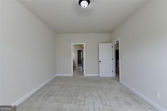 unfurnished bedroom featuring light carpet