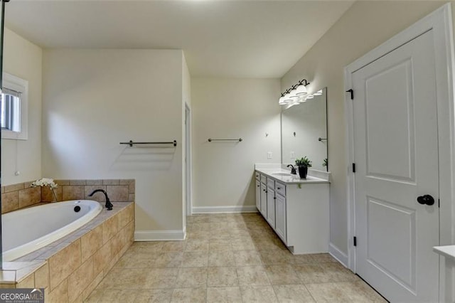 bathroom featuring vanity, tiled bath, and tile patterned floors