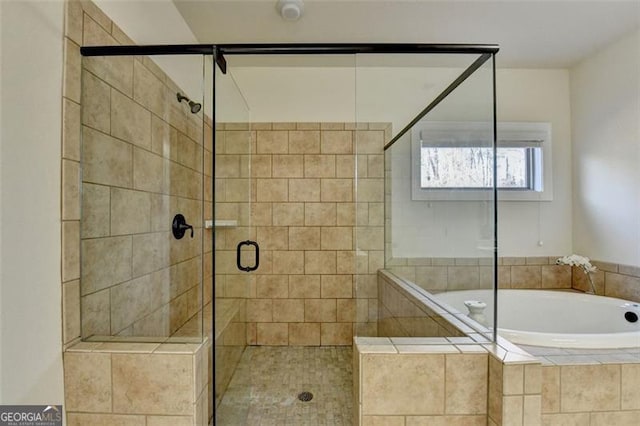 bathroom featuring separate shower and tub