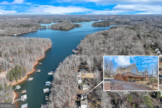 birds eye view of property with a water view