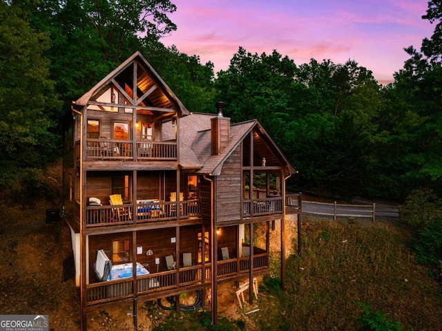 273 Deer Crest Hts, Blue Ridge, GA 30513 - back house at dusk featuring a balcony