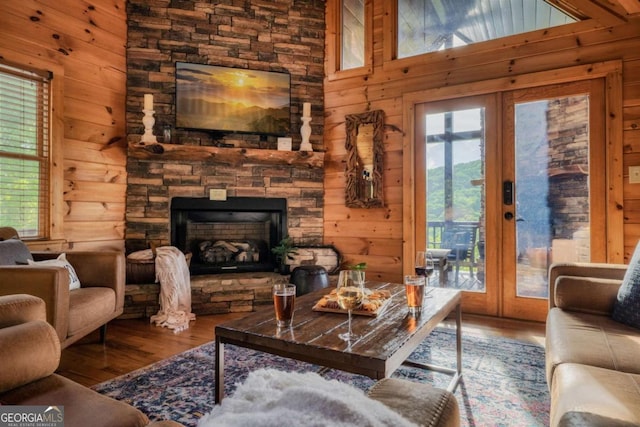 273 Deer Crest Hts, Blue Ridge, GA 30513 - living room with french doors, wood-type flooring, wooden walls, and a stone fireplace