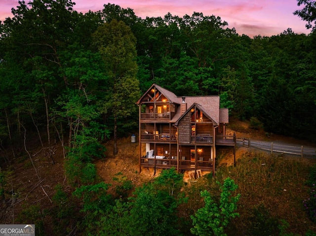 273 Deer Crest Hts, Blue Ridge, GA 30513 - back house at dusk featuring a balcony