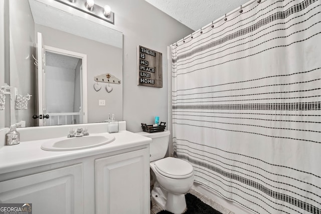 bathroom featuring vanity, curtained shower, toilet, and a textured ceiling