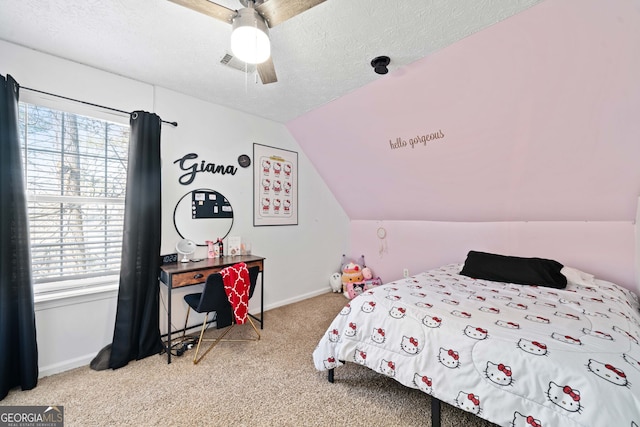 bedroom with ceiling fan, lofted ceiling, carpet floors, and a textured ceiling