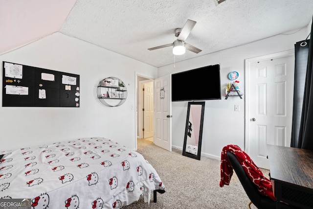 bedroom featuring ceiling fan, a textured ceiling, light carpet, vaulted ceiling, and a closet