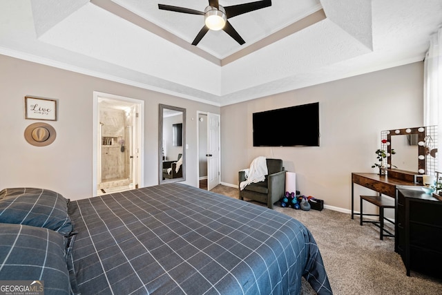 carpeted bedroom featuring ensuite bath, ceiling fan, a tray ceiling, crown molding, and a textured ceiling