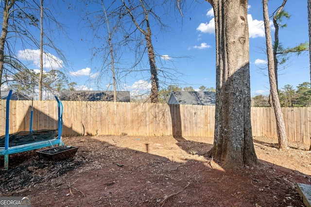 view of yard with a trampoline