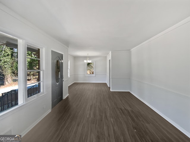 unfurnished room with dark hardwood / wood-style floors and a chandelier