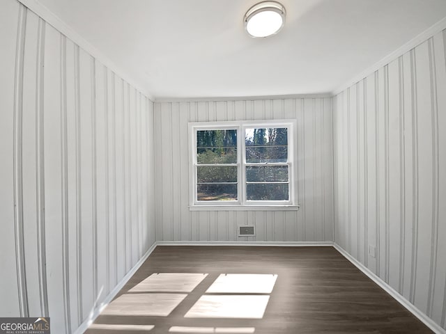 unfurnished room with dark wood-type flooring