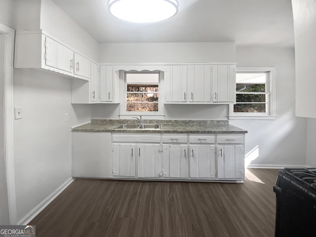 kitchen with white cabinetry, sink, dark wood-type flooring, and black gas range