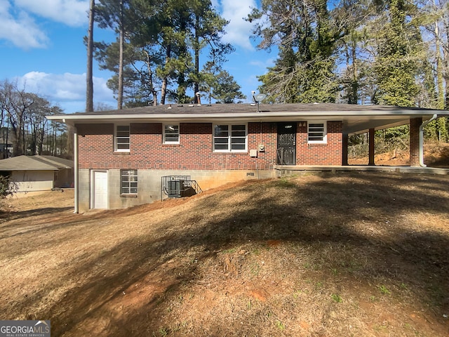 rear view of property with a yard and central air condition unit