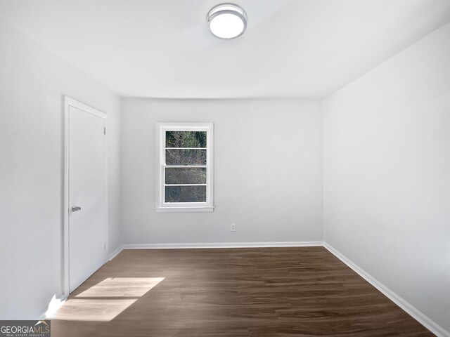 empty room featuring dark hardwood / wood-style flooring