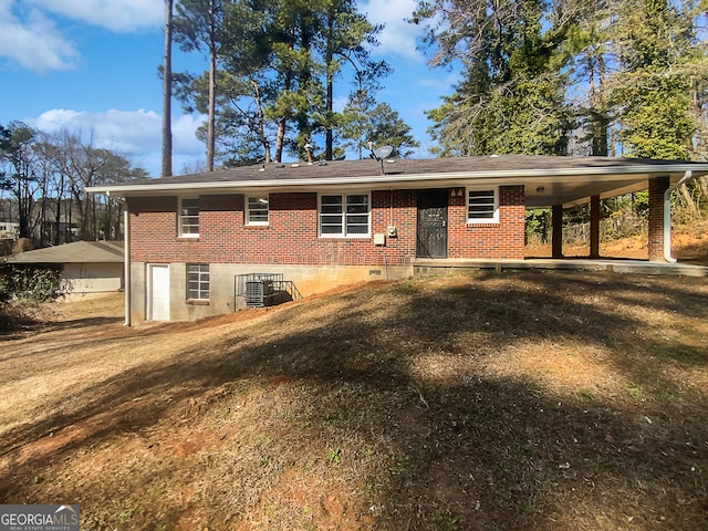 rear view of house featuring a lawn and central air condition unit