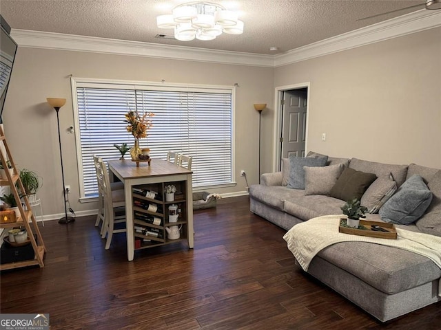 living room featuring an inviting chandelier, crown molding, dark wood-type flooring, and a textured ceiling