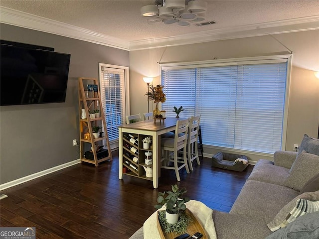 dining room featuring crown molding, dark hardwood / wood-style floors, ceiling fan, and a textured ceiling