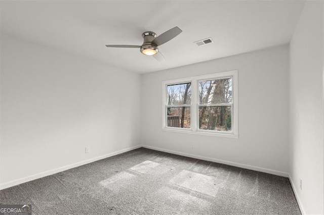 carpeted spare room with ceiling fan