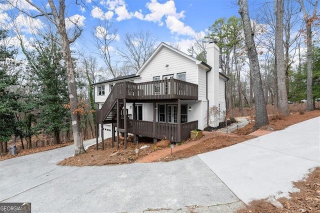 view of front of home with a garage and a wooden deck