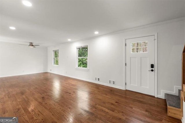 foyer featuring dark wood-type flooring, ceiling fan, and ornamental molding