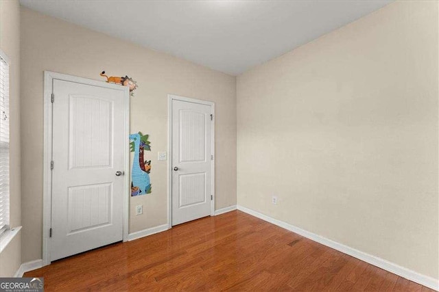 unfurnished bedroom with hardwood / wood-style floors