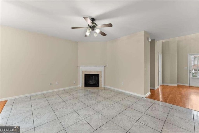 unfurnished living room featuring light tile patterned flooring and ceiling fan