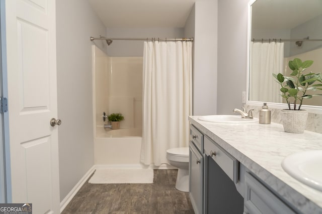 full bathroom with vanity, hardwood / wood-style floors, toilet, and shower / tub combo with curtain