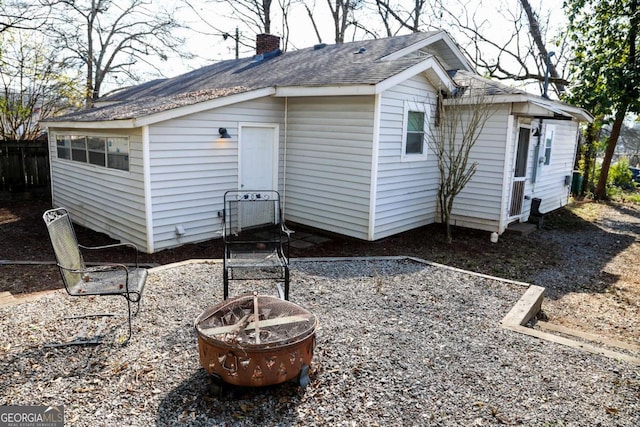 rear view of house featuring a fire pit