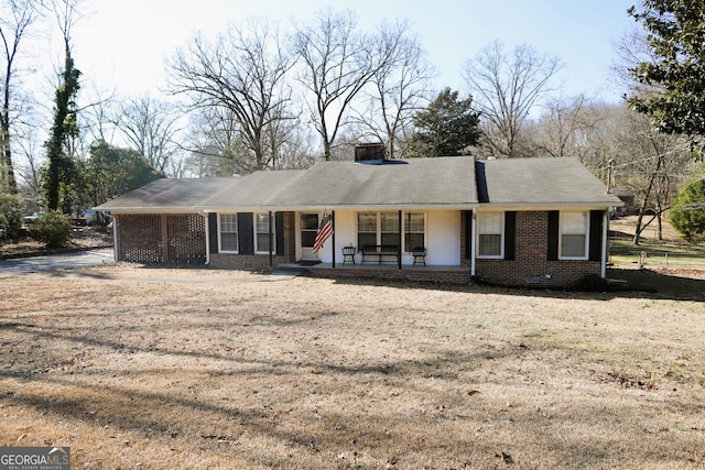 ranch-style house with a front lawn and covered porch