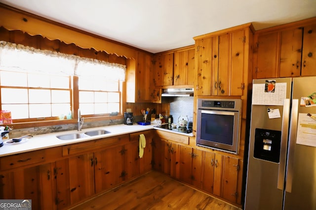 427 Oak Hill Dr, Trion, GA 30753 - kitchen with appliances with stainless steel finishes, under cabinet range hood, brown cabinets, and light countertops