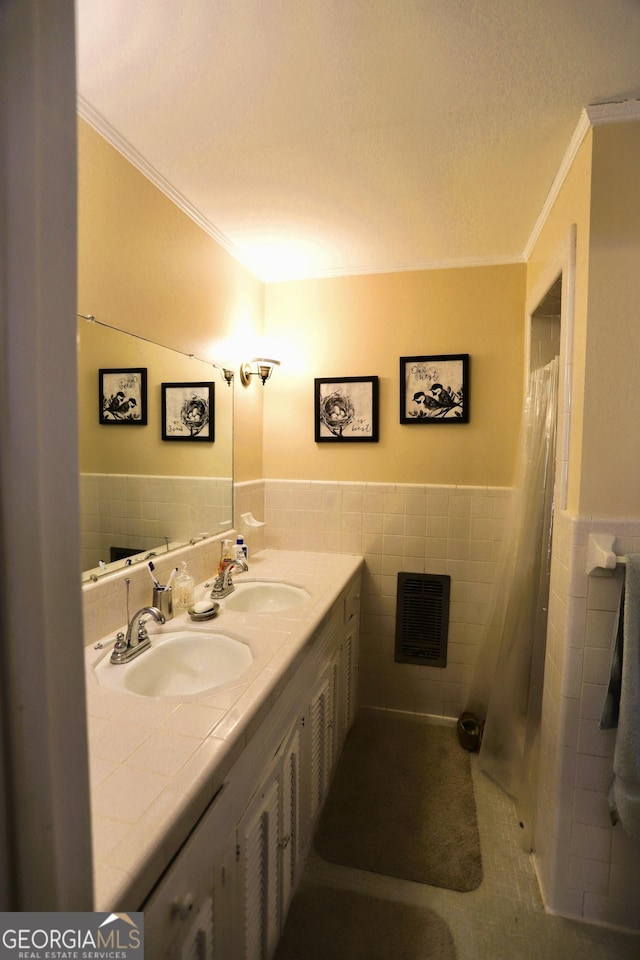 bathroom with crown molding, tile walls, and vanity