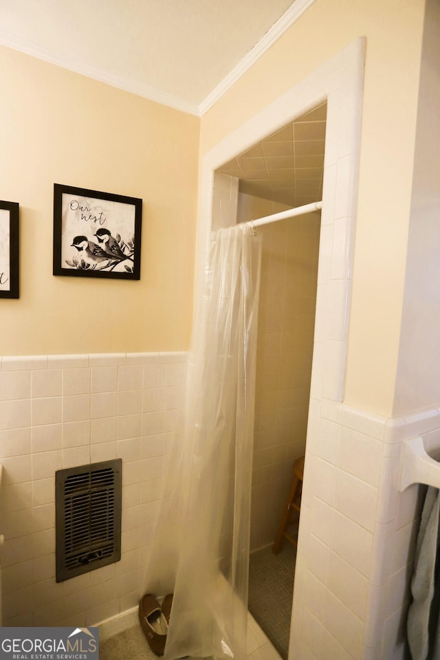 bathroom with walk in shower, ornamental molding, tile walls, and heating unit