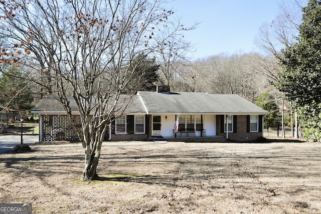 single story home with a porch and a front lawn