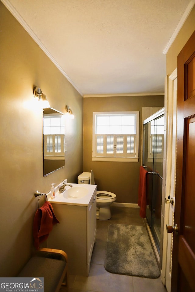 bathroom featuring crown molding, vanity, toilet, and an enclosed shower