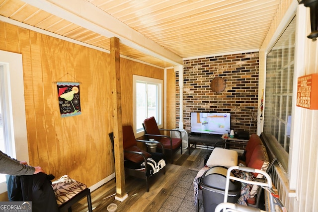 interior space with wooden walls, dark hardwood / wood-style flooring, and beam ceiling