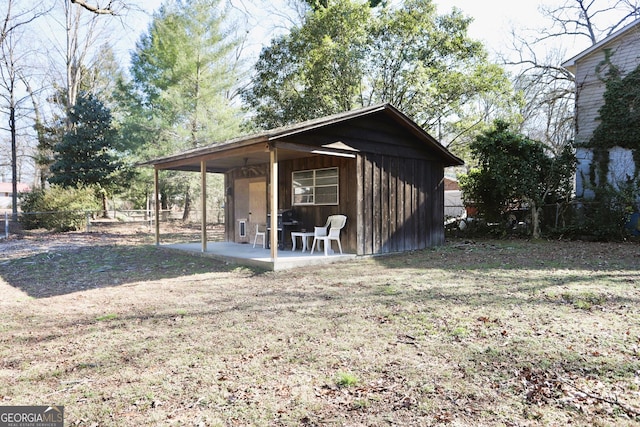 view of outbuilding with a lawn