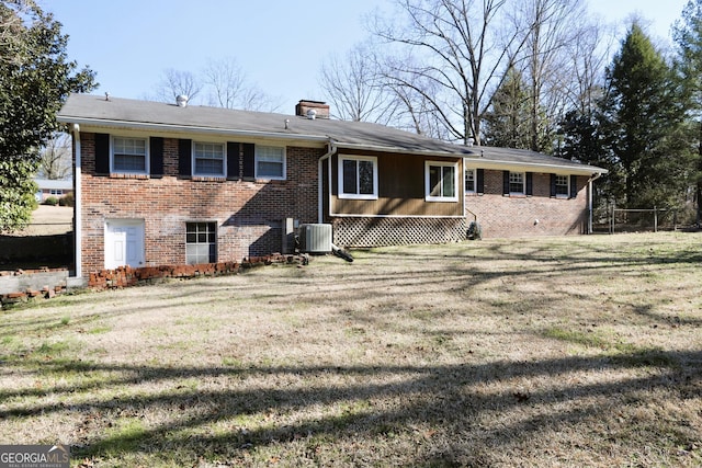 view of front of home with cooling unit and a front yard