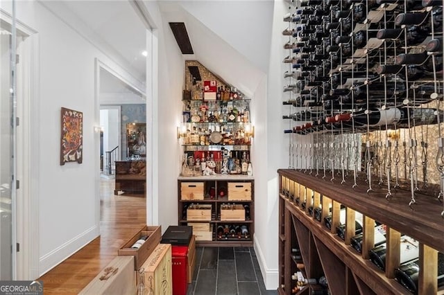 wine cellar with dark hardwood / wood-style flooring