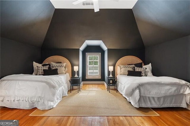 bedroom with wood-type flooring and lofted ceiling