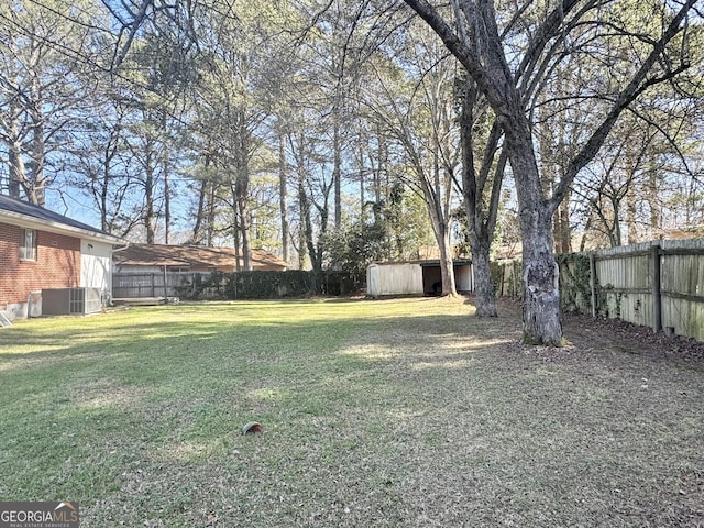 view of yard featuring an outdoor structure and central AC unit