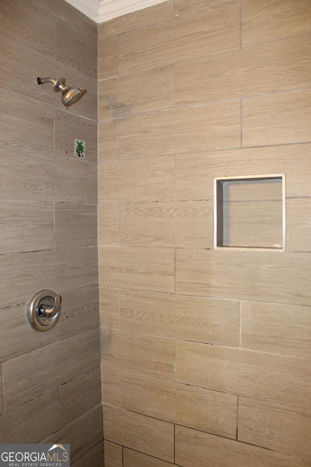 bathroom with a tile shower