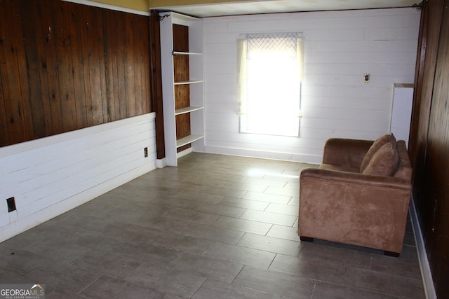 living area featuring wooden walls