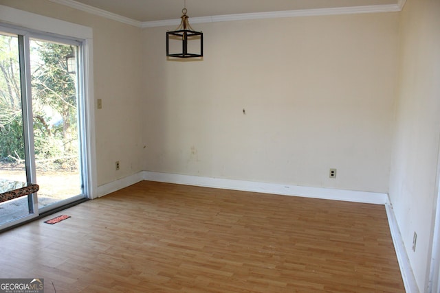 unfurnished dining area featuring wood-type flooring, ornamental molding, and a healthy amount of sunlight